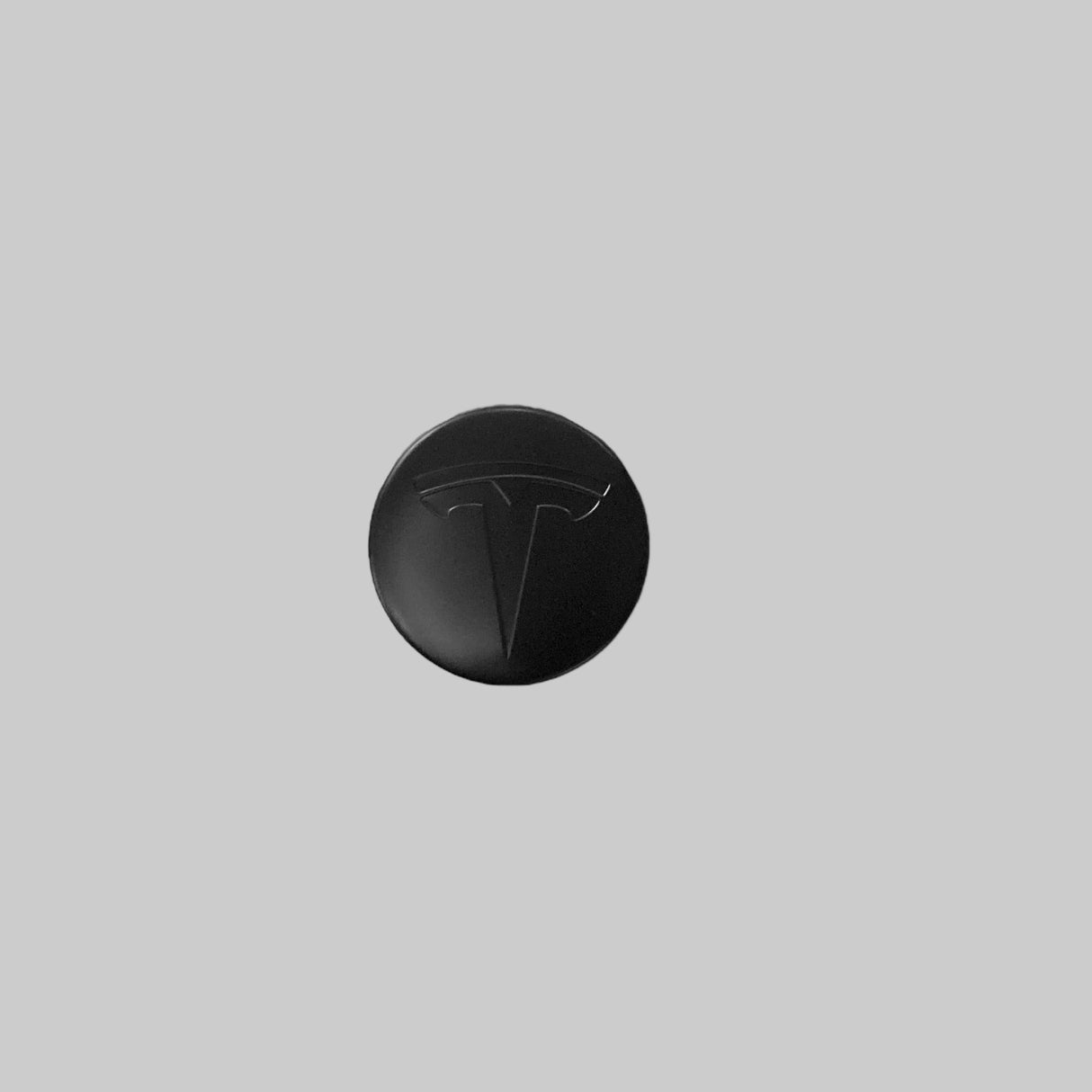 Centerkapsel med et sort Tesla logo