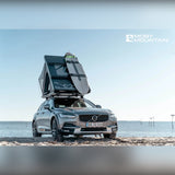 Moby Mountain Swell M tagtelt i slateGrey med stige på Volvo V90 Cross Country ved vandet